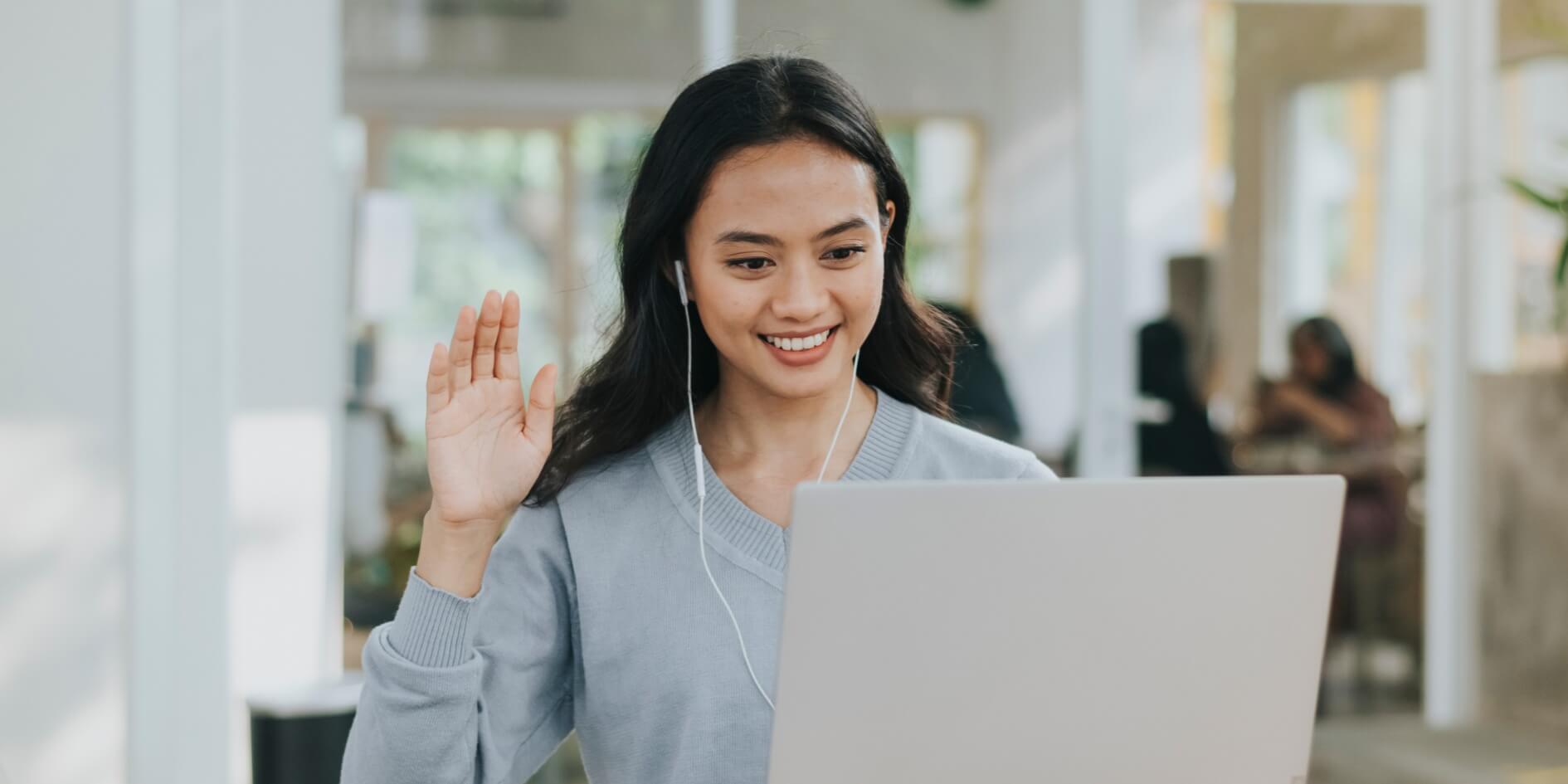 A woman engaging in a video call with teammates.