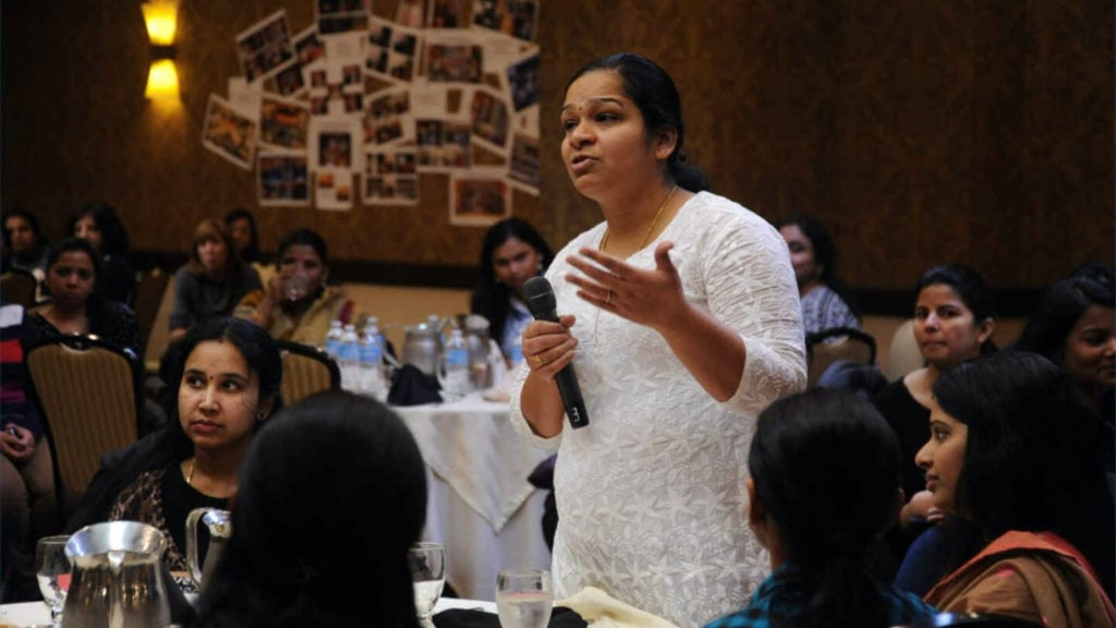 Woman asking a question in a culture of transparency.